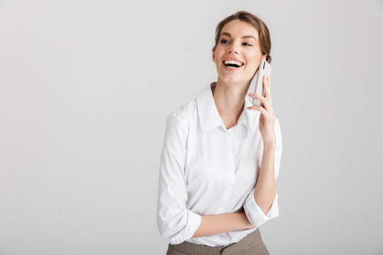 Image of pleased beautiful woman laughing and talking on mobile phone