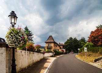 Flowering village in Alsace. Decoration of street lamps with potted flowers and plants.