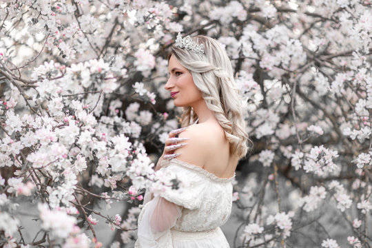 Fantasy photography - beautiful white princess with blooming tree