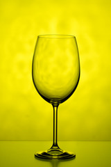 One glass on a yellow background