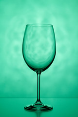 One glass on a green background