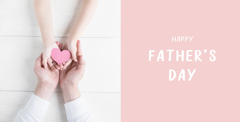 Happy father's day.Greeting card.Heart in the hands of daughter and father on a white background.I love you, dad.Love and health in the family.Banner for the sale in store,website.Flat lay.top view.