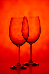 Two glasses for wine on a yellow-red background