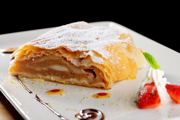 Traditional pieces of apple strudel with cinnamon,raisin, powdered sugar