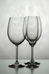 Three glasses of wine. One for champagne and two for wine on a light background.