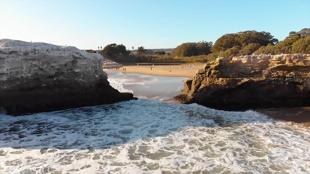 santa cruz natural Bridges State beach drone flying through rocks over waves