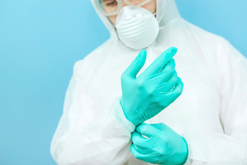 close-up portrait of tired doctor after shift in the hospital. The doctor in protective clothing - glasses, mask, gloves on white background. The doctor treating patients with coronavirus. Covid-2019