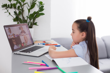 cheerfully cute girl children excited using computer learning schoolwork. kid enjoy e-learning in holiday at home.