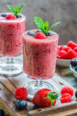 Mixed berry smoothie garnished with fresh fruit and mint