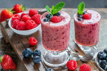 Mixed berry smoothie garnished with fresh fruit and mint