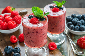 Mixed berry smoothie garnished with fresh fruit and mint