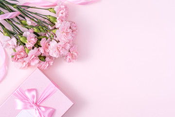 Fototapeta na wymiar Mother's Day, Valentine's Day background design concept, beautiful pink carnation flower bouquet on pastel pink table, top view, flat lay, copy space.