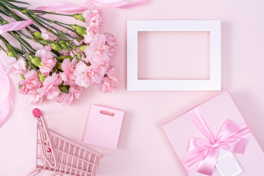 Mother's Day, Valentine's Day background design concept, beautiful pink carnation flower bouquet on pastel pink table, top view, flat lay, copy space.