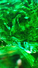 A piece of thick green glass, a beautiful abstraction form, a beautiful pattern, close-up. Wallpaper, background abstraction