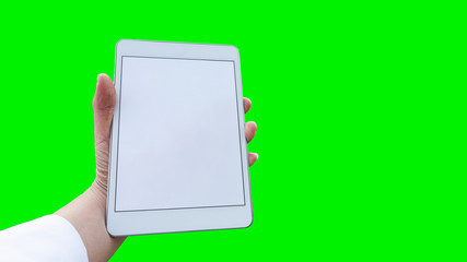 Tablet with a white screen in the hand, green background