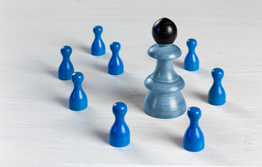Pawns of Different Sizes on a White Table