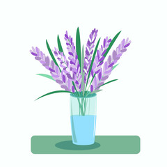 A bouquet of lavender flowers in a vase on the table