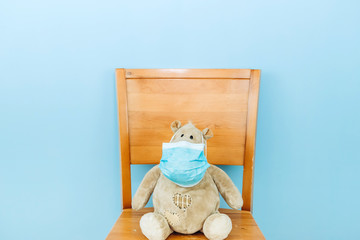 teddy bear and hippo in a medical mask on a blue background. Concept of 2019-20 coronavirus Covid-19 pandemic.