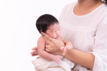 Beautiful young Asian mother hold tiny adorable newborn baby girl 0-1 month with her hand to help...