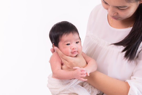 Beautiful young Asian mother hold tiny adorable newborn baby girl 0-1 month with her hand to help baby belch or Making burp after feeding with caring and love, lifestyle health care newborn at home