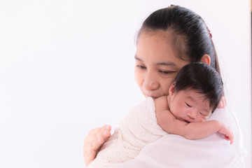 Beautiful young Asian mother hold newborn baby 0-1 month on shoulder rub hand back with love and comfortable infant, toddler sleep on shoulder mom feeling safety and trust, motherhood tasking at home