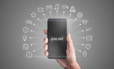 Girl showing mobile phone and various functional pictograms on imaginary screen, grey background....