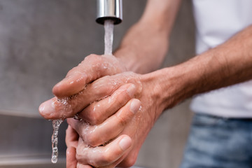 Close up view of man washing hands