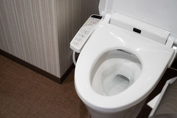 Modern high tech toilet with electronic bidet in Japan. Industry leaders recently agreed on signage...