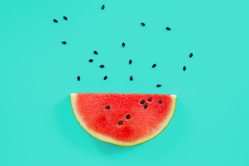 Slice of watermelon on green background.
