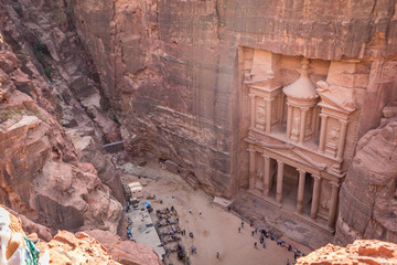 The Petra's Treasury and canyon from above with lot of tourist