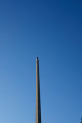 a camera on top of a tower with blue sky 