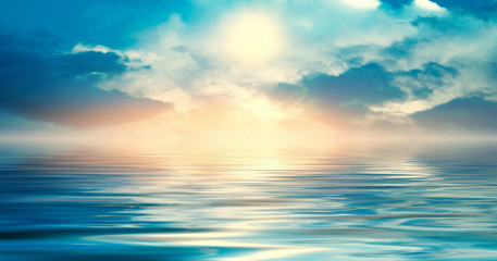Naklejka na ściany i meble Background of a sea landscape. Blue sky with clouds over the sea. Sunlight, sunset