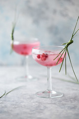 Pink mocktail close up. Beverage with rose and prosecco wine in drinkware. Exotic French Martini...