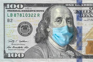COVID-19, sars-cov-2 coronavirus pandemic going to a financial crush, one hundred dollars USA bill with Benjamin Franklin wearing a protective mask