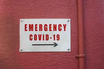 closeup of french hospital emergency entry sign on red wall background