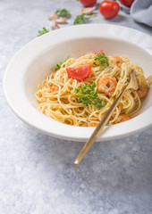 spagetti marinara with shripms.  pasta dish on grey concrete  table