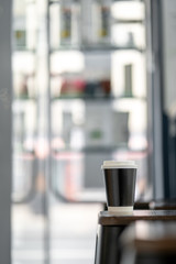 Cup of coffee to go in coffee house cafe daylight sunrise sunset morning city street