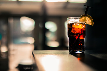 Glass of cola / soda on bar in restaurant