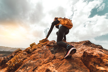 Success woman hiker hiking on sunrise mountain peak - Young woman with backpack rise to the...