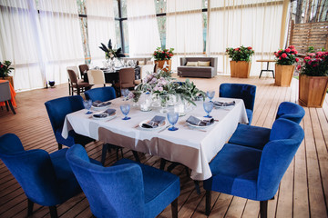 Empty glasses set in restaurant. Part of interior. Magic blue colors.