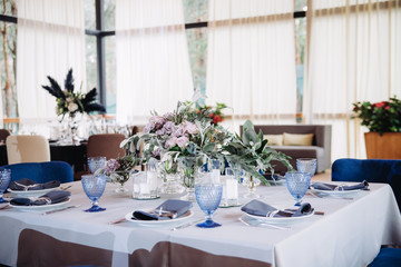 Empty glasses set in restaurant. Part of interior. Magic blue colors.