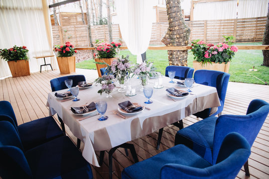 Empty glasses set in restaurant. Part of interior. Magic blue colors.