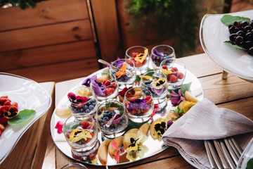 Delicious snacks on wedding reception table in luxury outdoor restaurant.