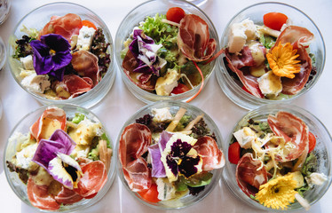Delicious snacks on wedding reception table in luxury outdoor restaurant.