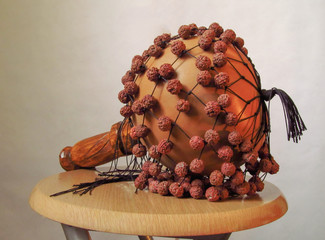 Musical instrument shaker calabash on a wooden chair