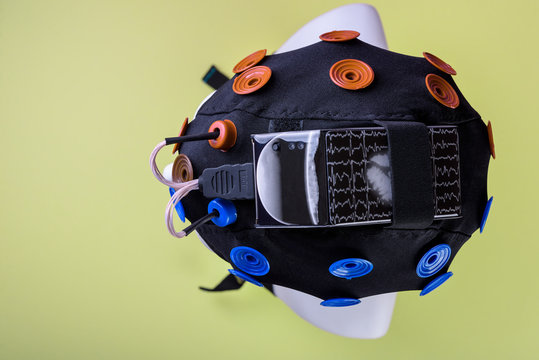 model head with EEG electrodes on yellow background , EEG headset equipment, EEG equipment