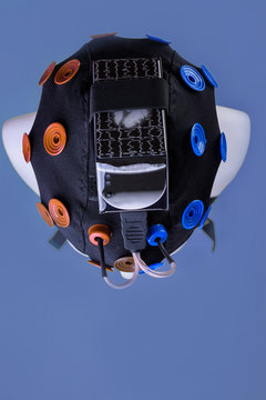 model head with EEG electrodes on blue background , EEG headset equipment, EEG equipment