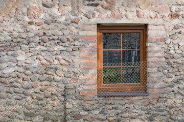 Fototapeta na wymiar Plastic window in an old stone house