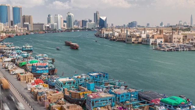 Loading a ship in port timelapse in Dubai, Deira creek, UAE. Aerial top view from above with many old boats and cargo ships