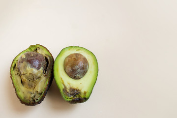 Bad and good avocado close-up on a white background. Concept for dealing with missing tropical...